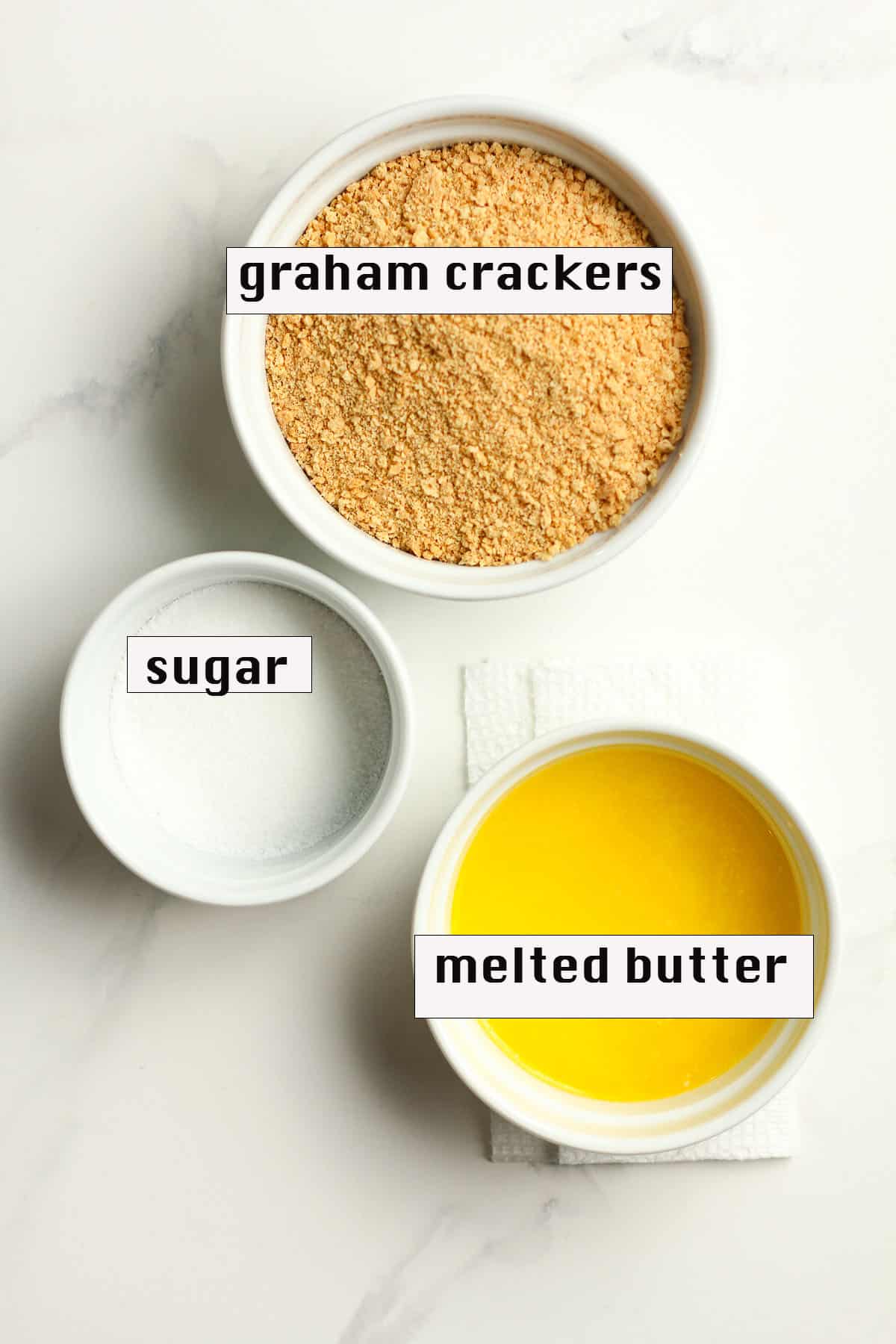 Bowls of the ingredients for the graham cracker crust.