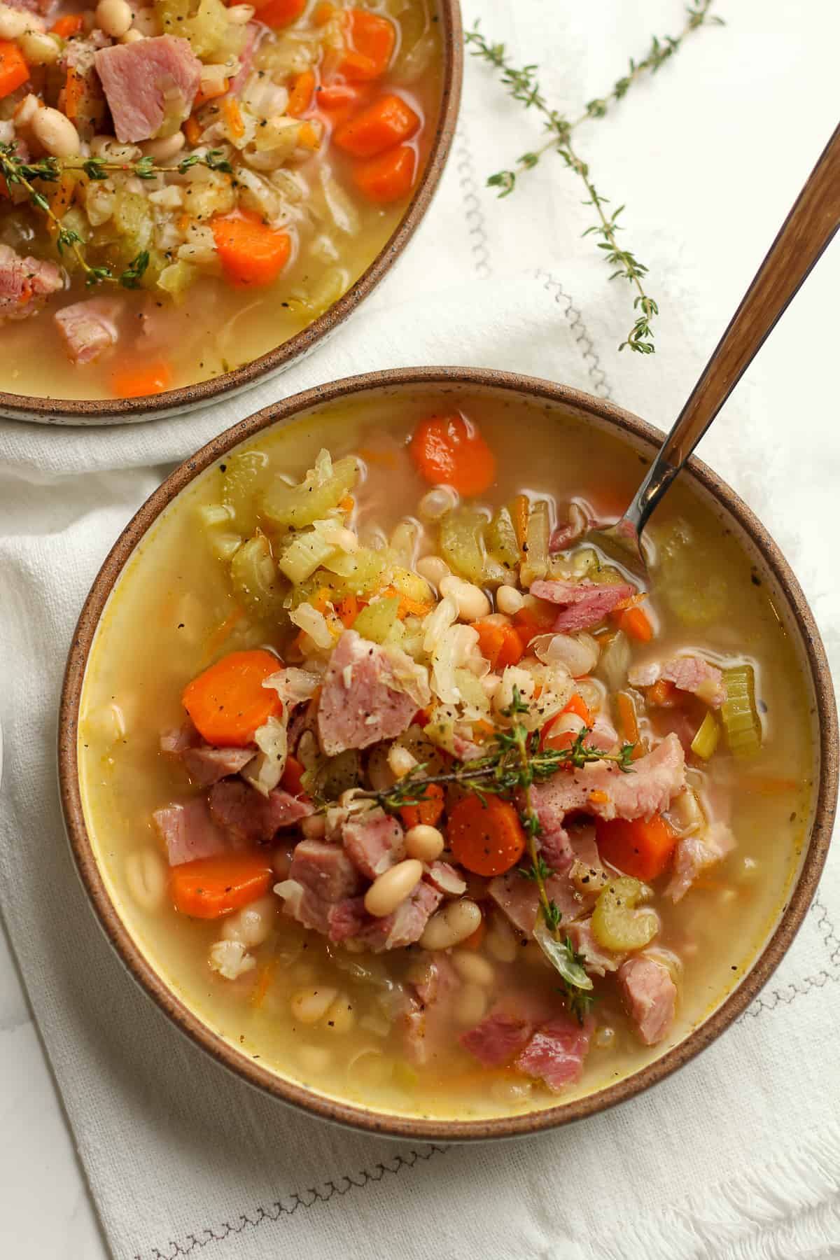 Bowls of leftover ham and white bean soup, with spoons.