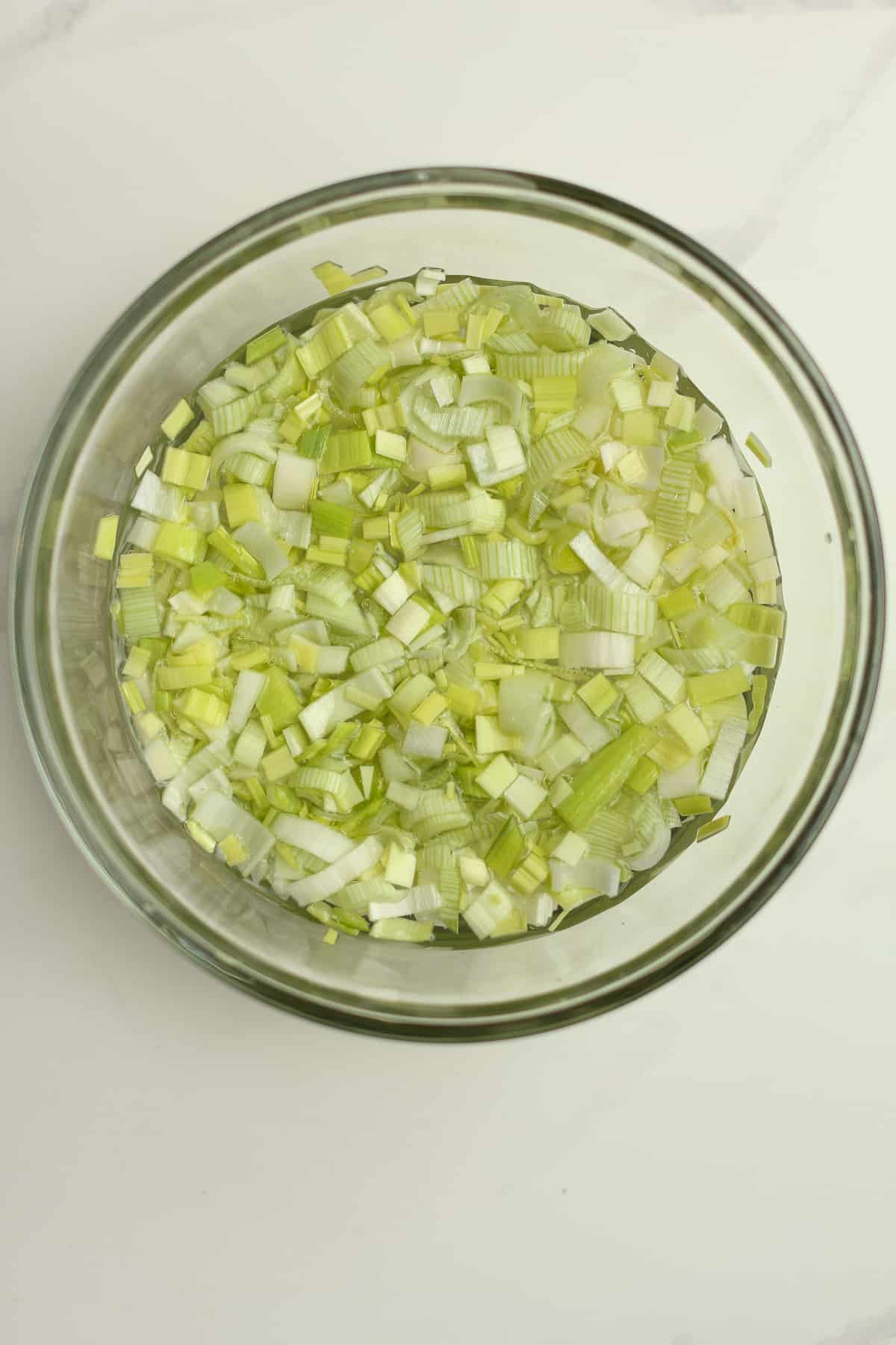 A bowl of the diced leek in water.