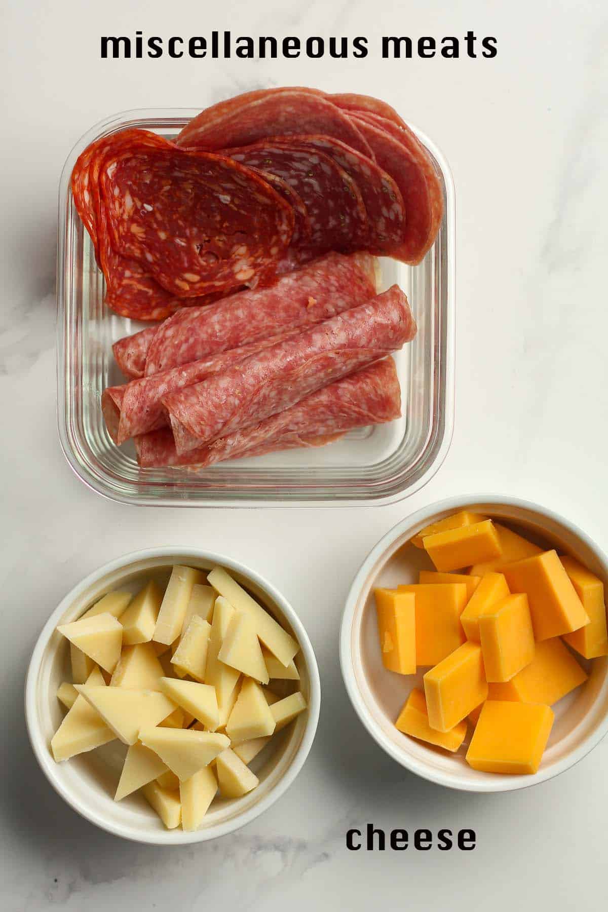 Bowls of meats and cheese.