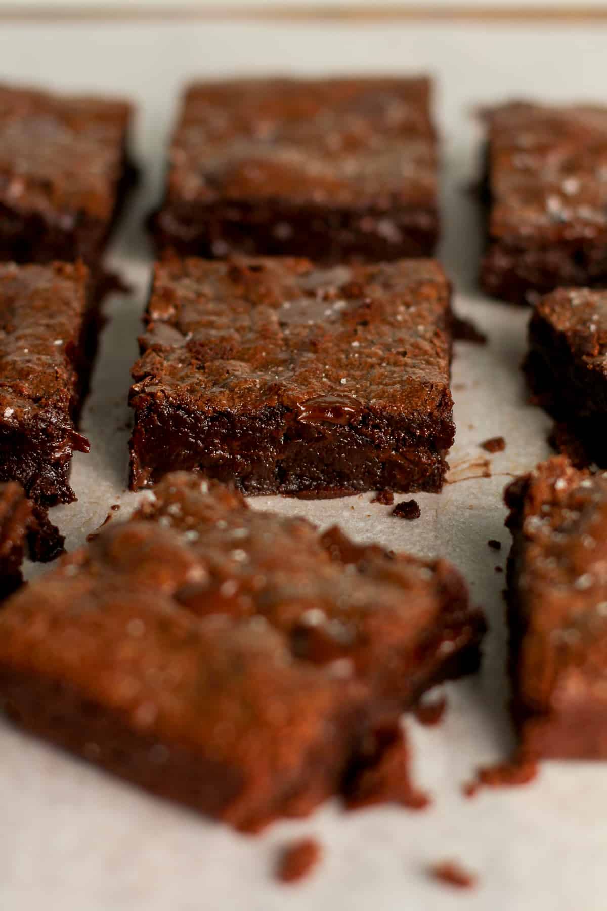 Side view of some sliced brownies pulled apart from each other.