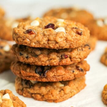 A stack of four oatmeal cookies with cranberries.