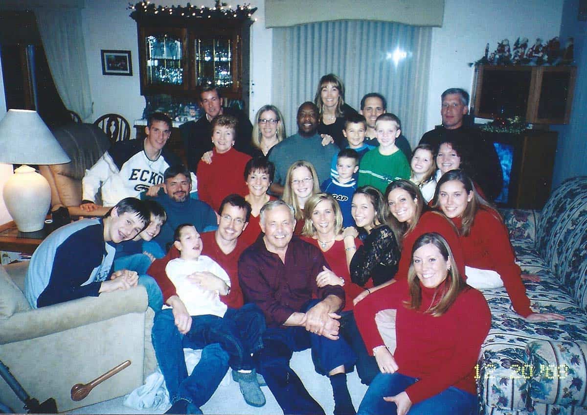 A picture of a bunch of the Reding family squashed into Dad and Mom's living room.