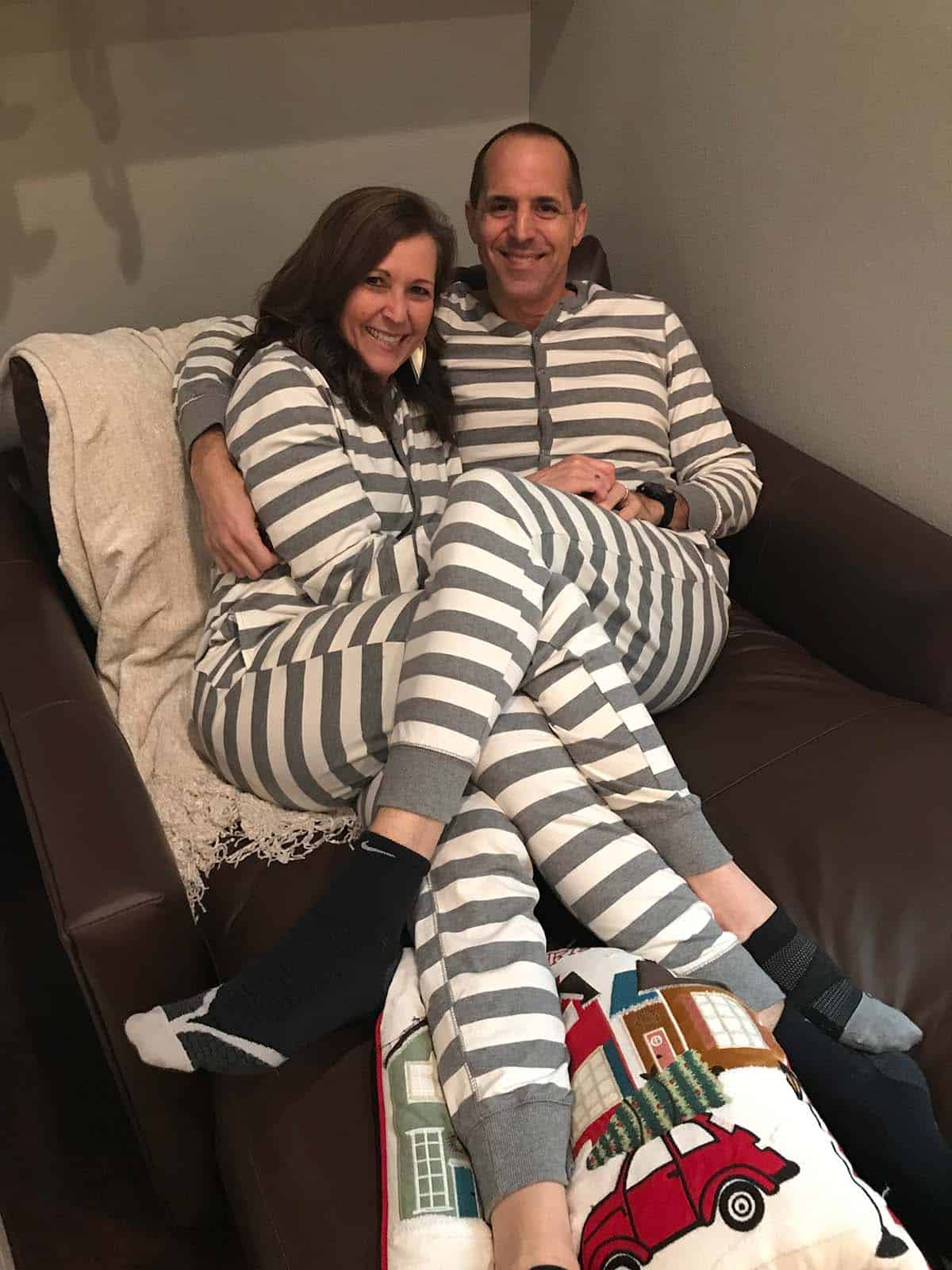 Mike and Sue snuggling in onesies.