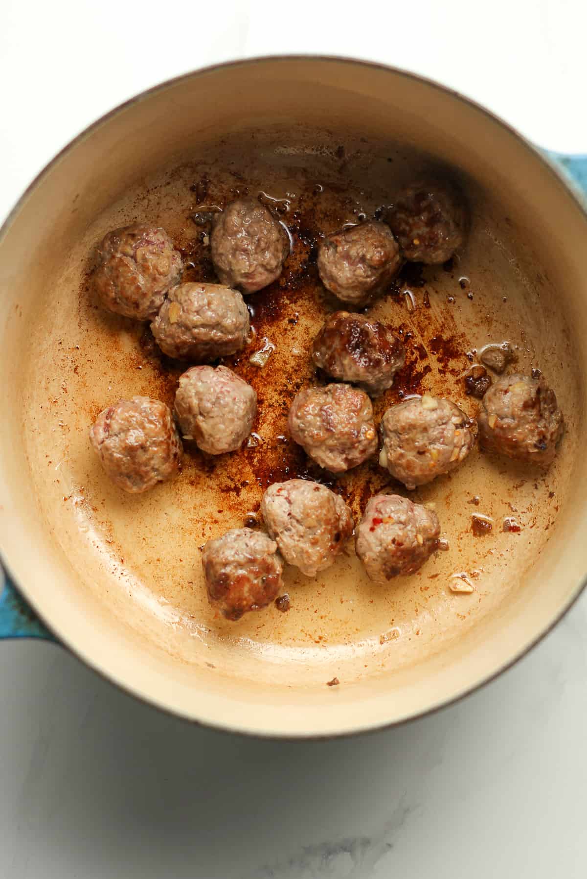 A stock pot of the browned meatballs.