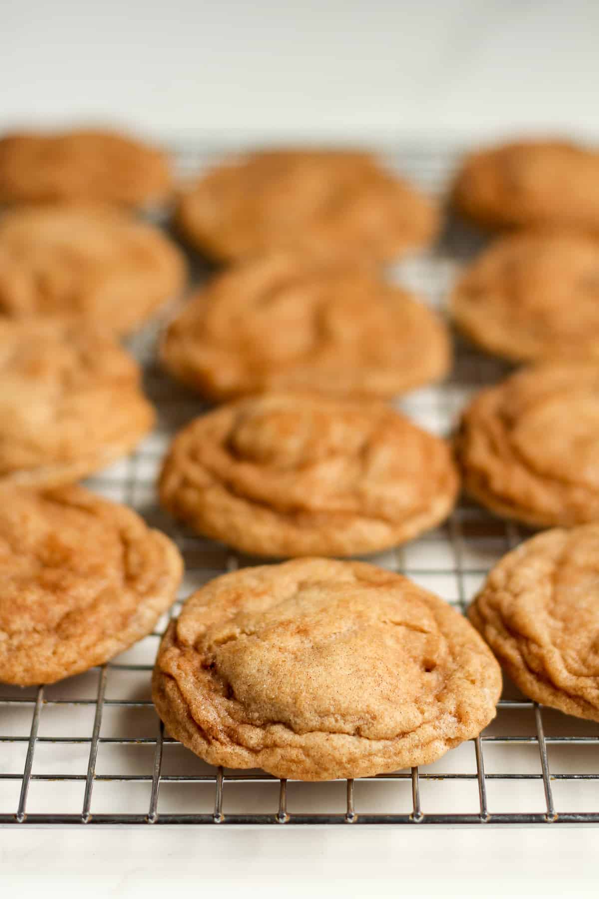 Side view of a cooling rack of baked snickerdoodle.