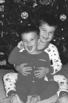 The boys in the pjs in front of our Christmas tree.