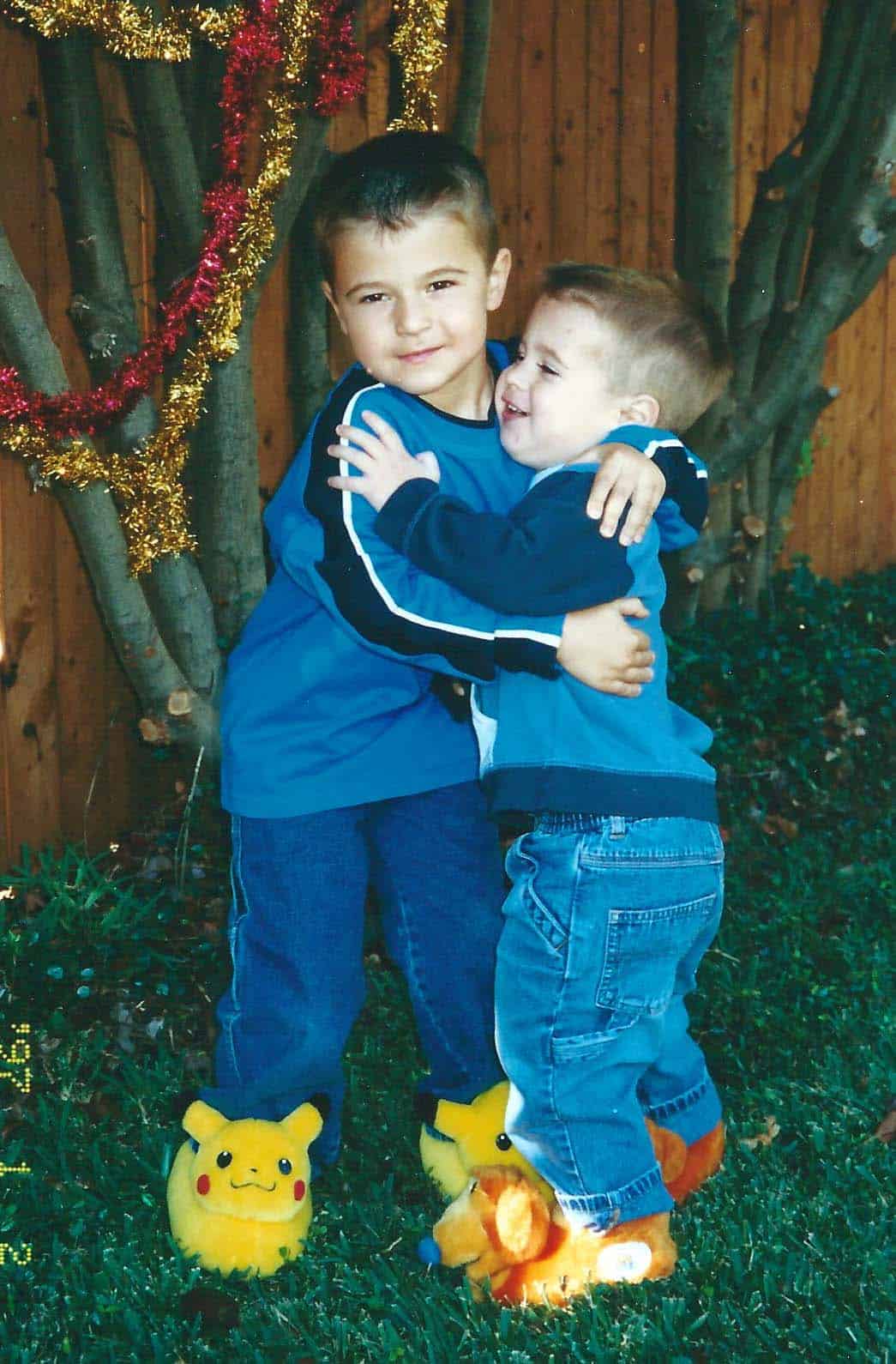 They boys outside in the cute slippers and matching shirts.