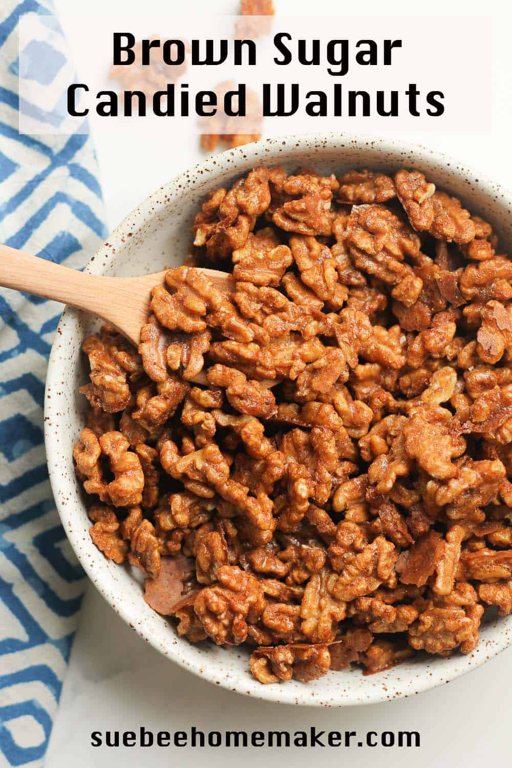 A bowl of candied walnuts with a spoon.