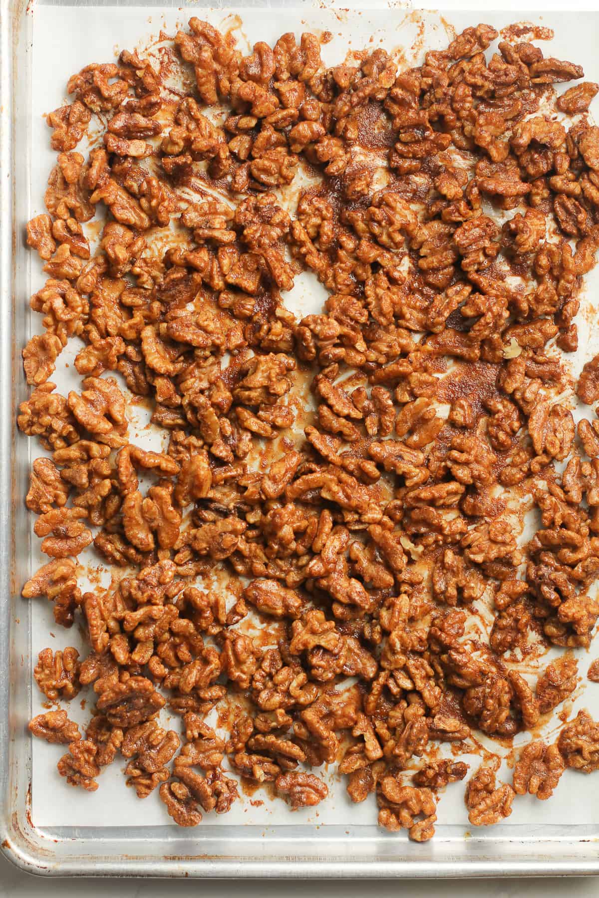 A baking sheet after baking the candied walnuts.