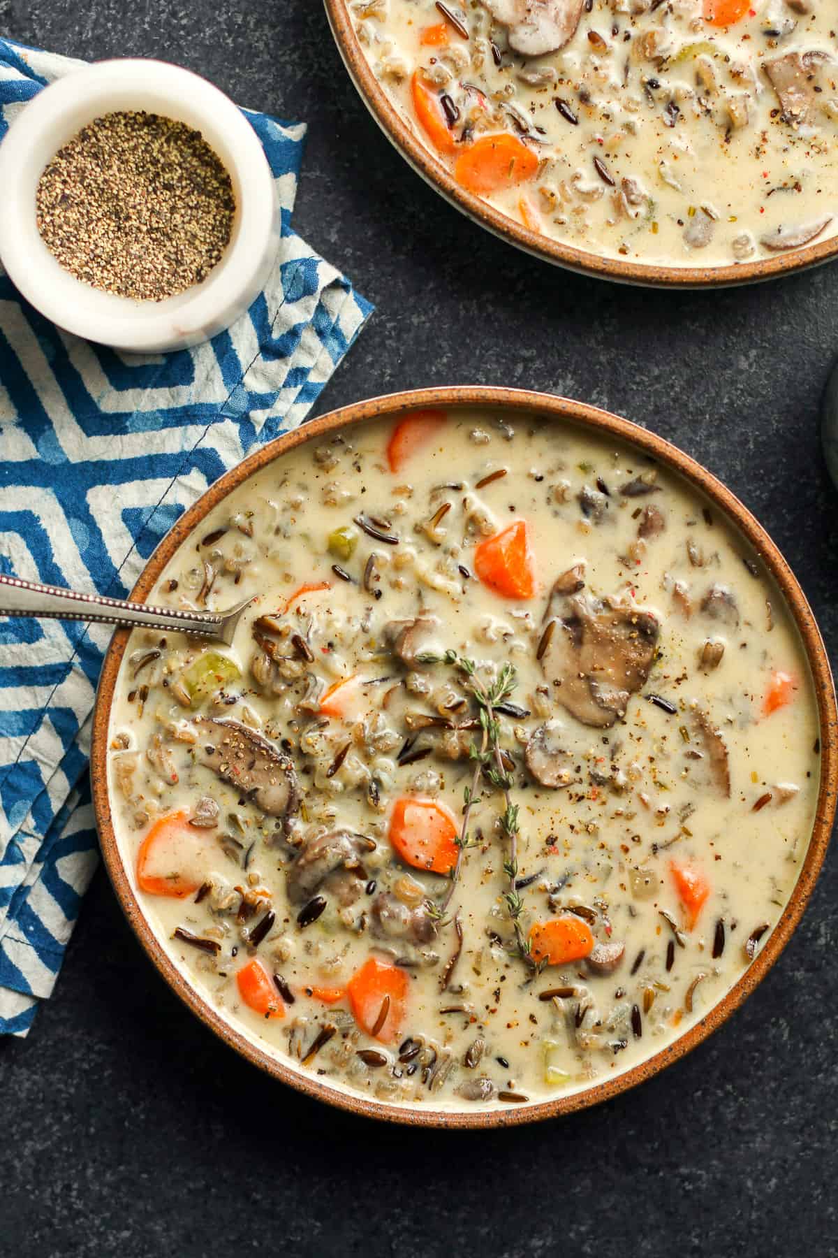 Two bowls of wild rice soup with mushrooms.