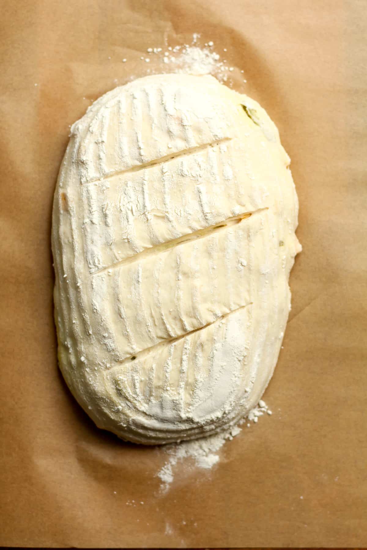 The loaf of dough formed with slits.