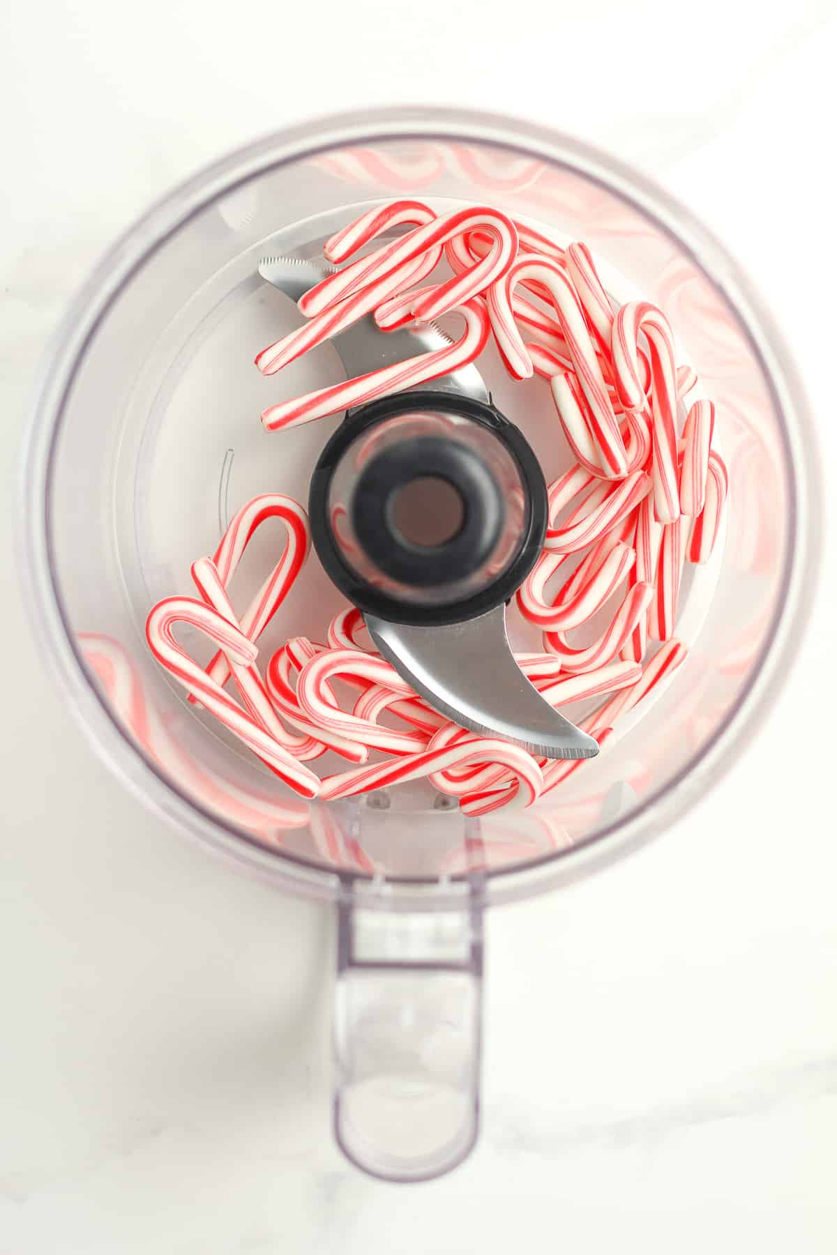 A food processor of small candy canes.