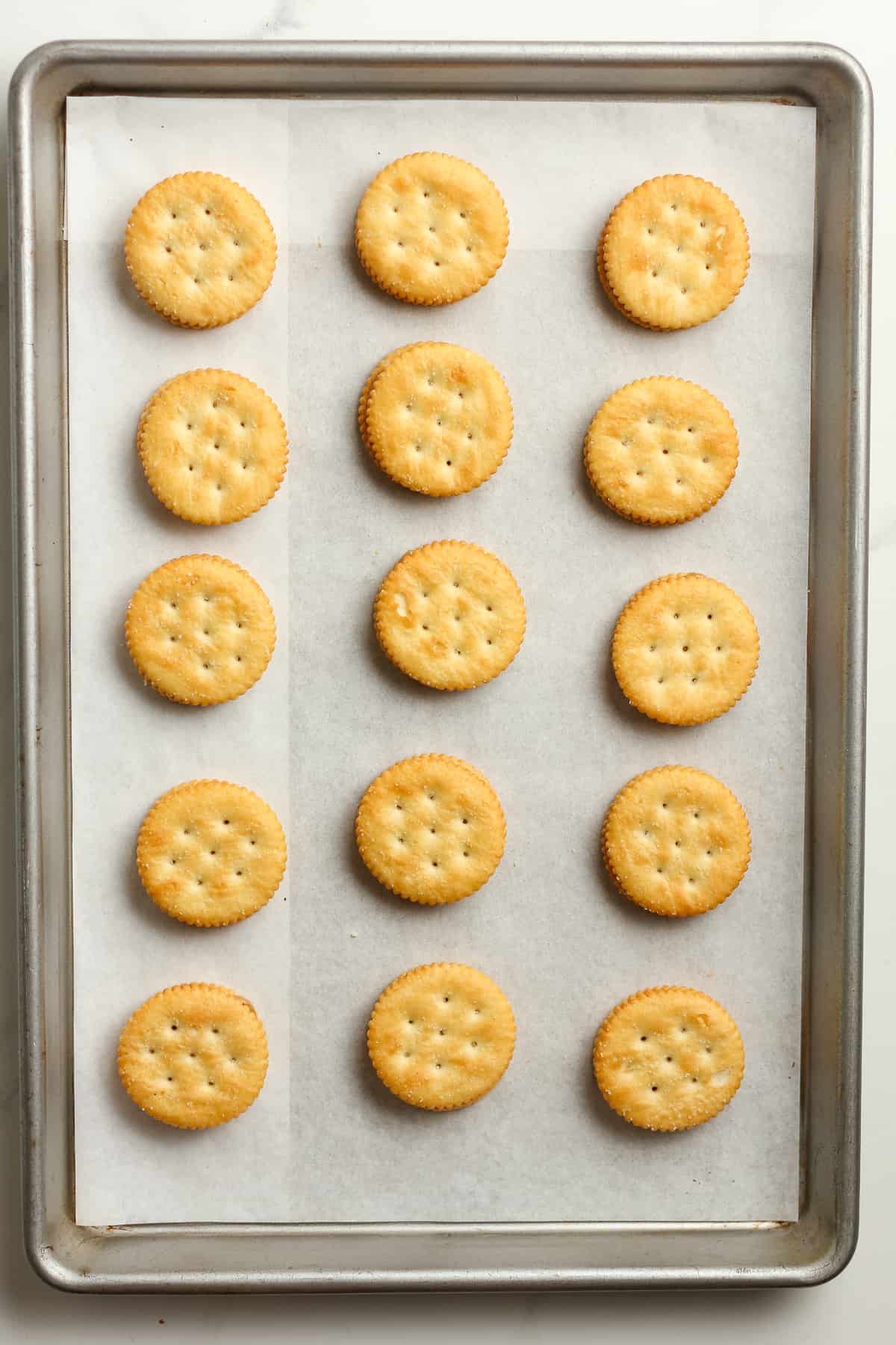 A pan of the ritz crackers with peanut butter.
