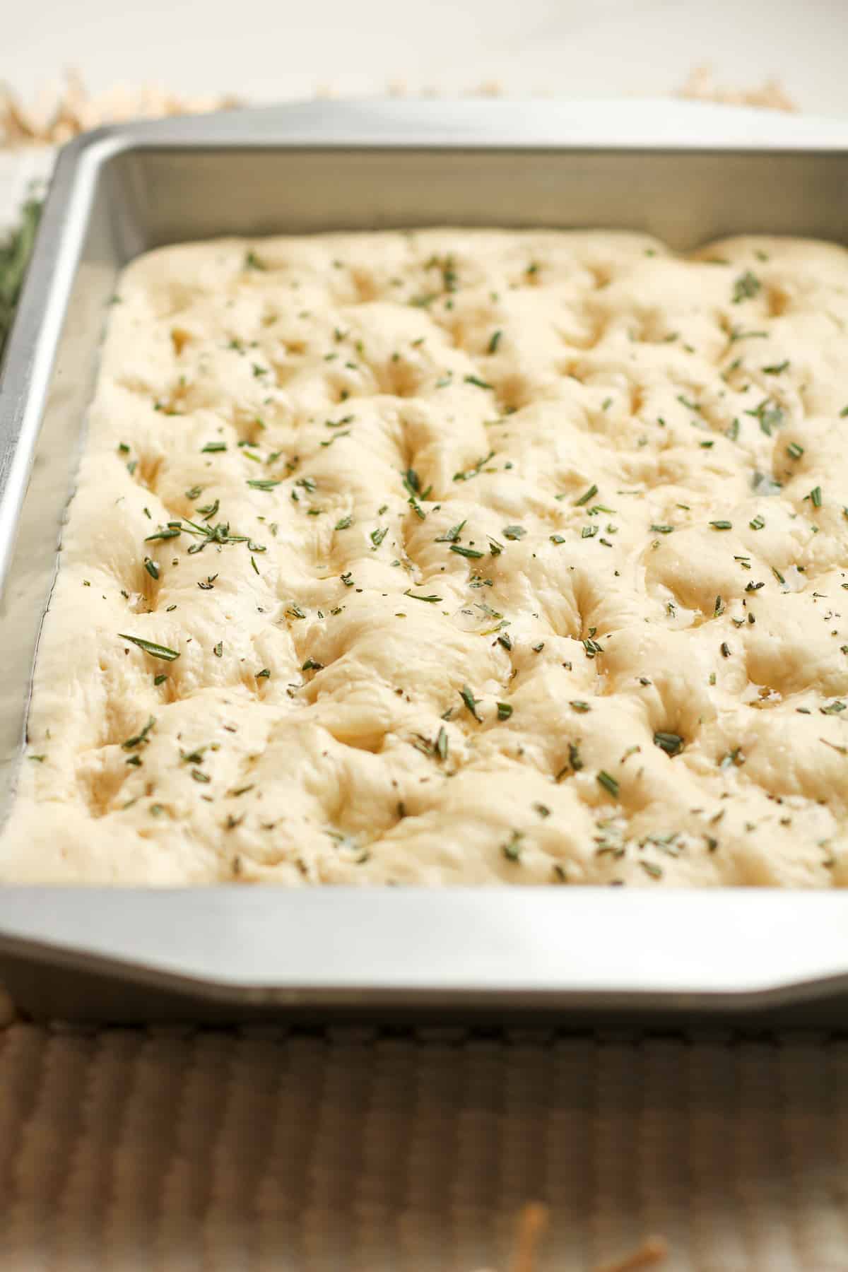 Side view of the focaccia dough in pan.