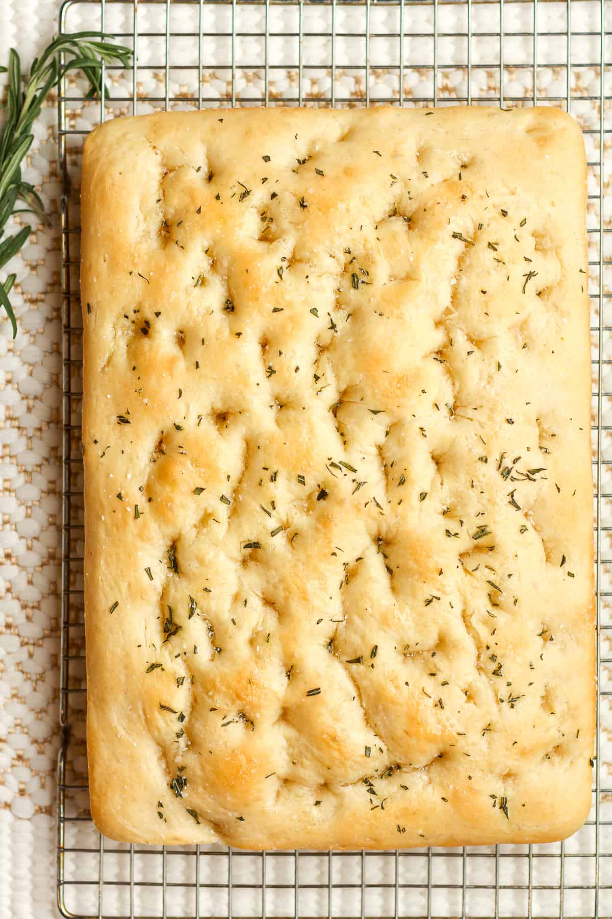 The rosemary focaccia bread on a cooling rack.
