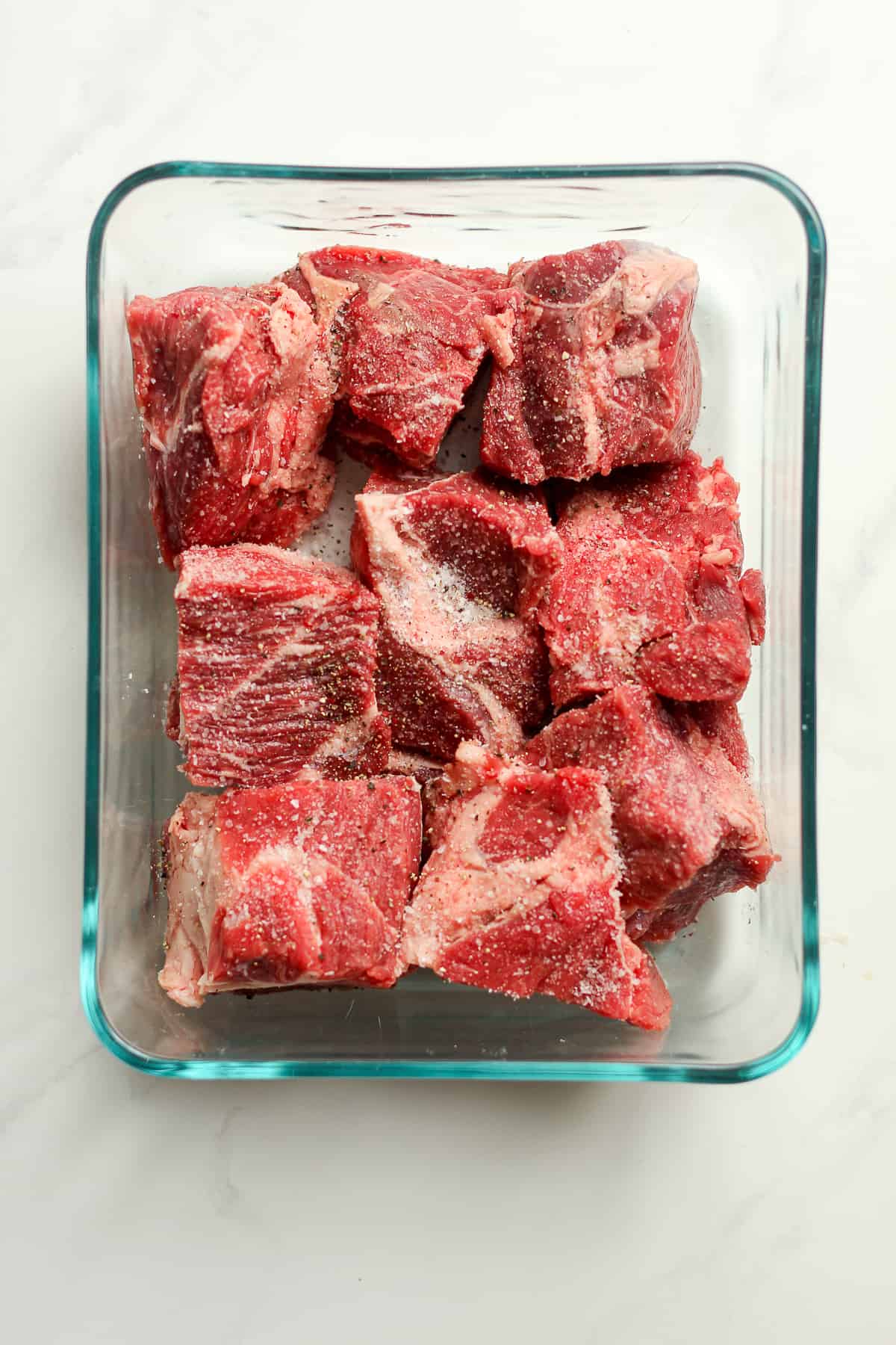 A dish of raw chunks of beef chuck.