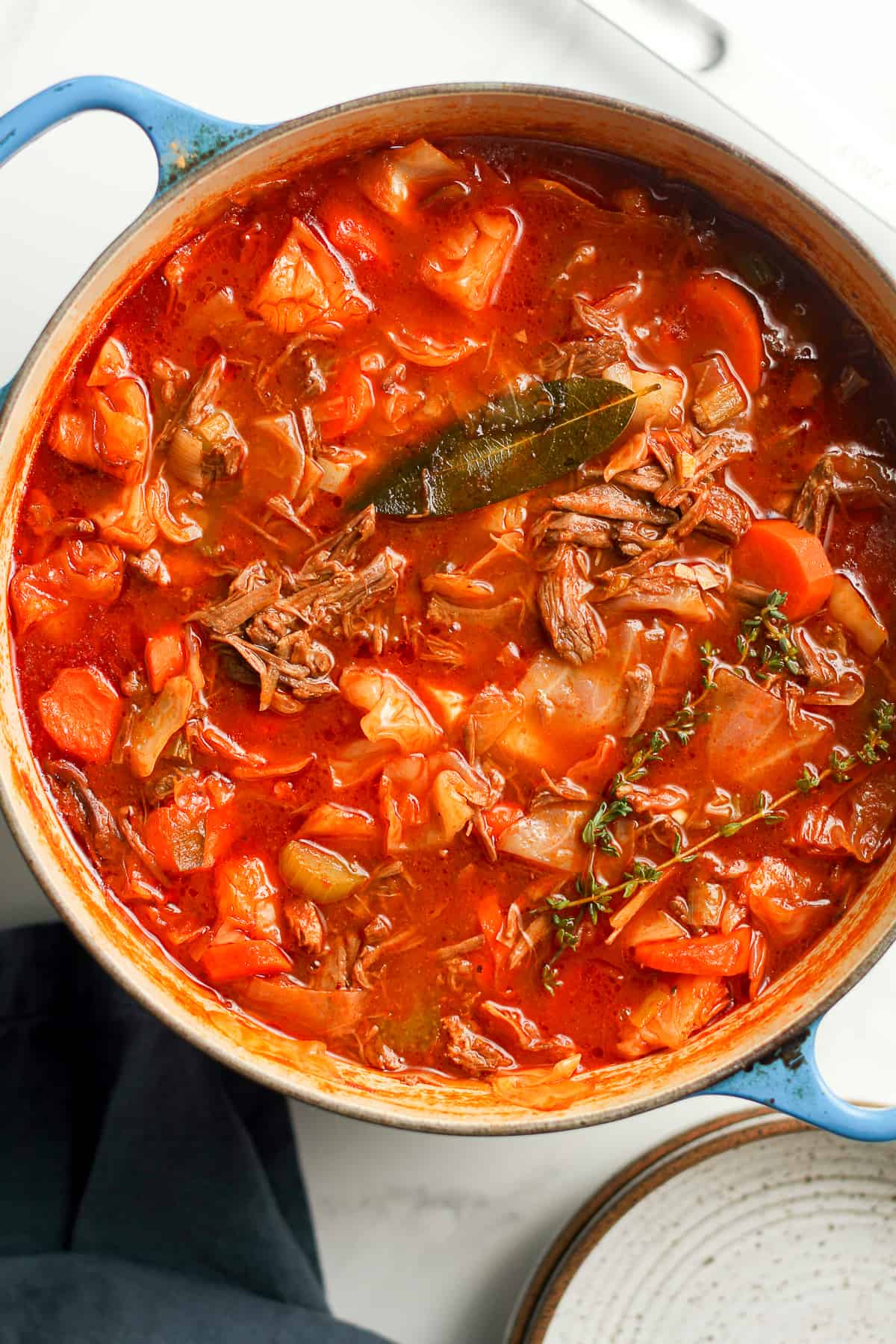 A stock pot of shredded beef cabbage soup.