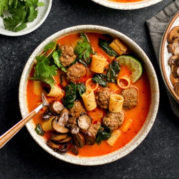 A bowl of Thai Meatball Soup, with mushrooms and pasta.