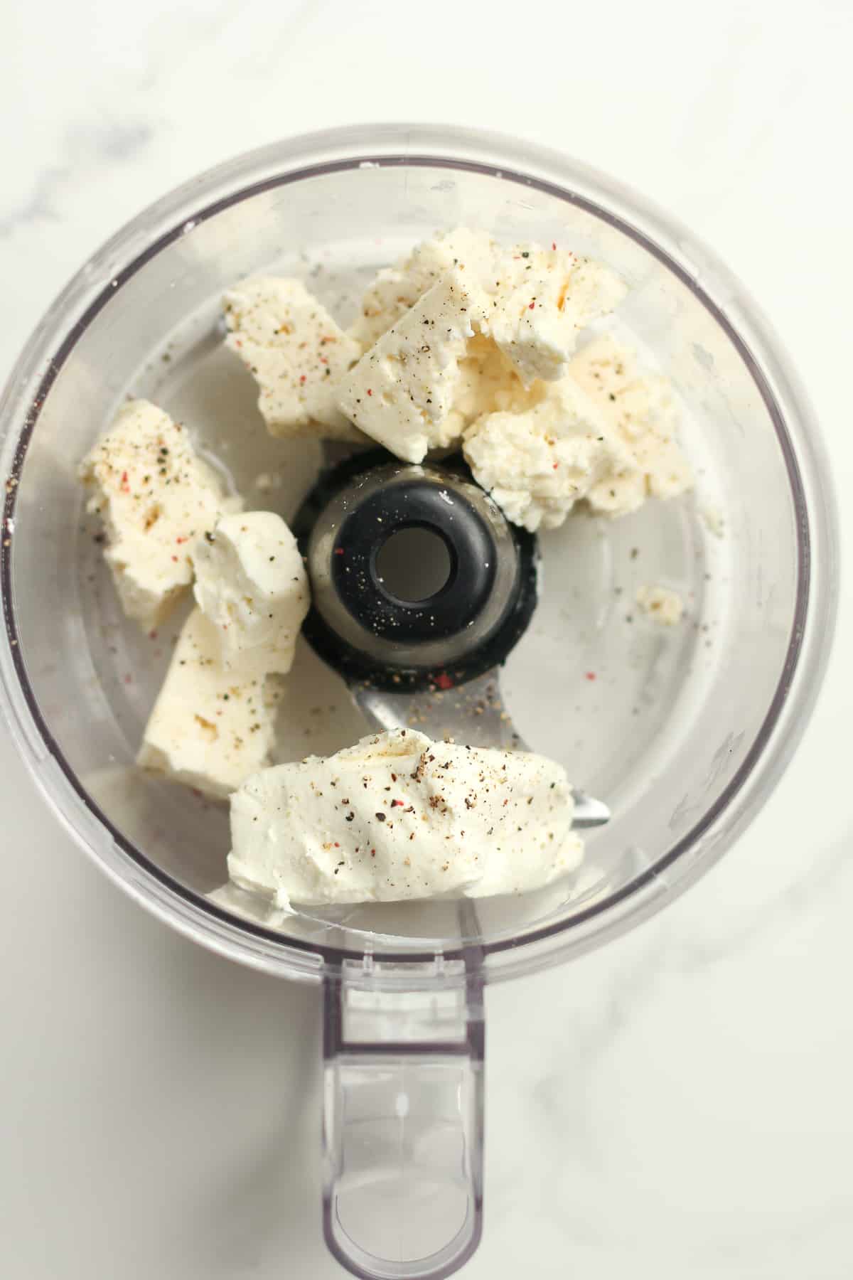 The food processor with the cheese.