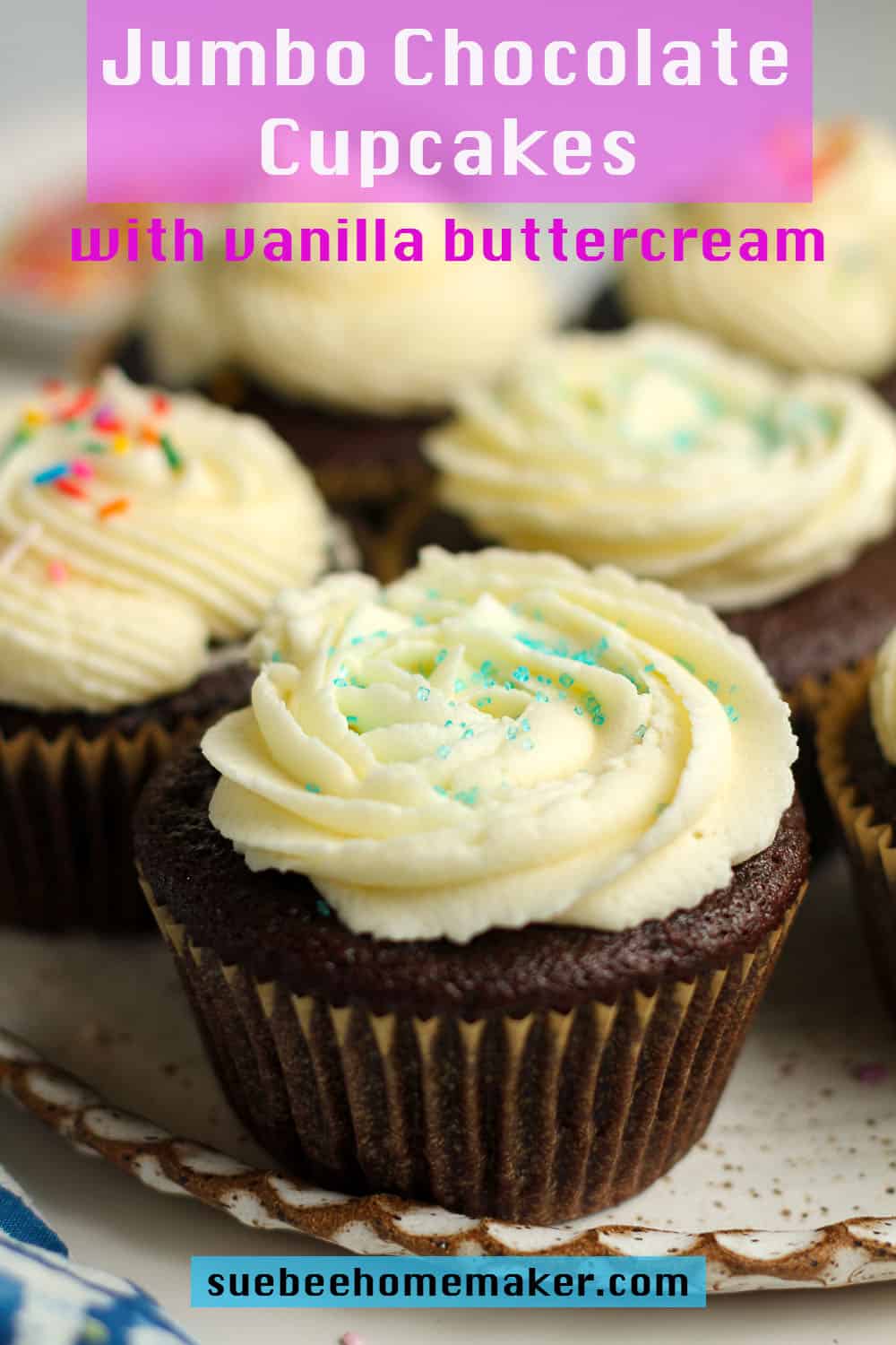 A plate of jumbo chocolate cupcakes with vanilla buttercream.