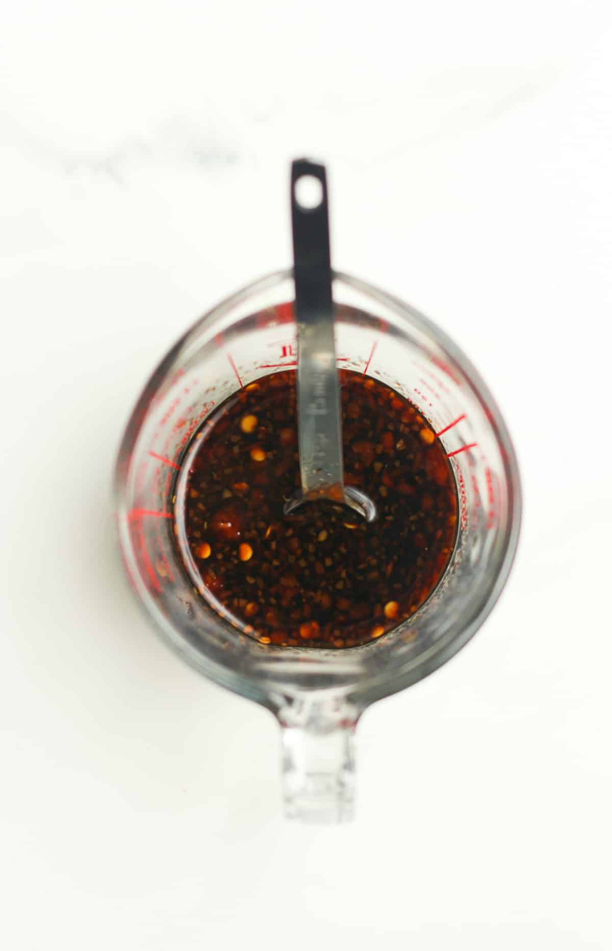 A measuring cup of the sauce.