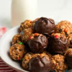 Side view of a bowl of monster cookie balls, no bake.