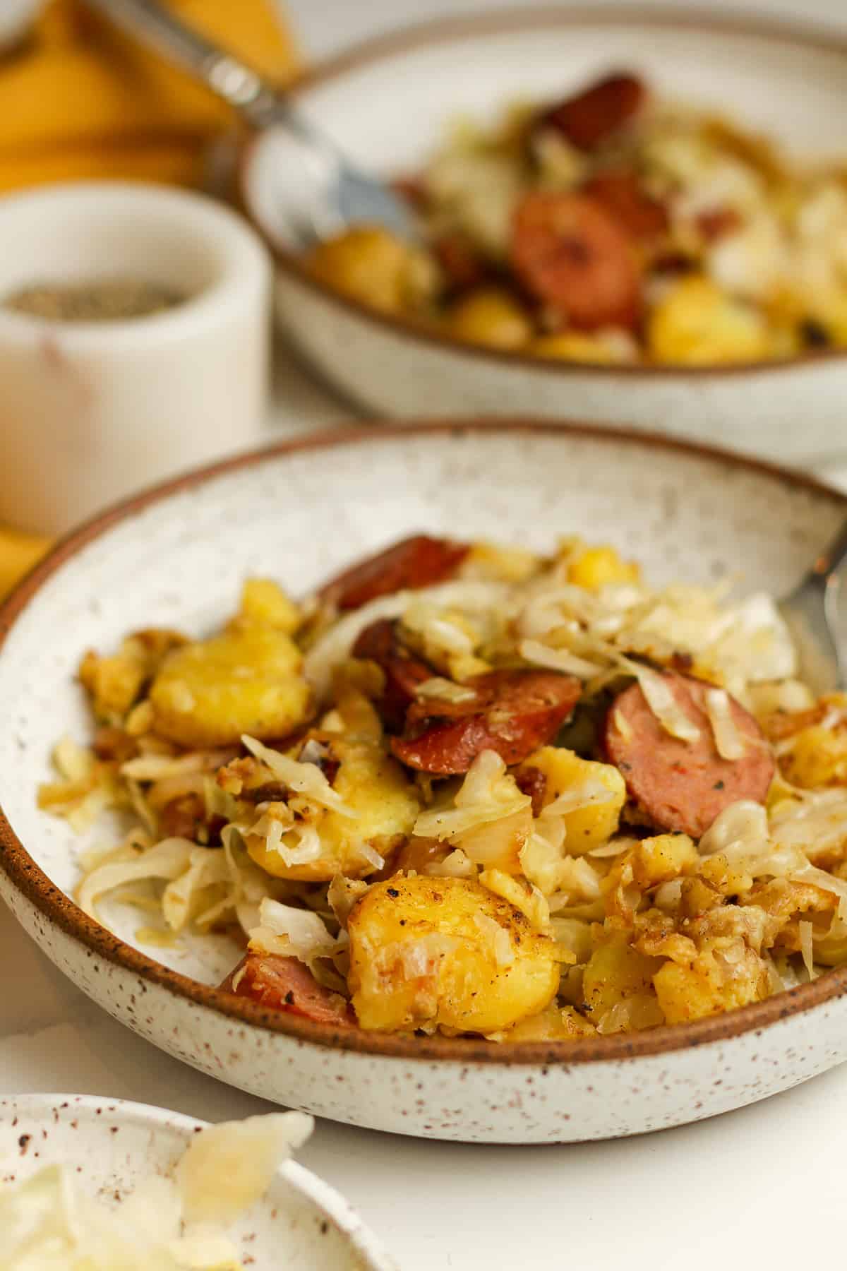 Side view of the bowls of sausage and sauerkraut.