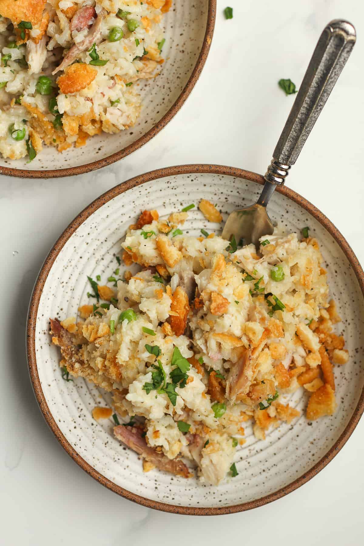 Two bowls of leftover turkey casserole with forks.