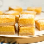A tray of lemon shortbread bars, some stacked up.
