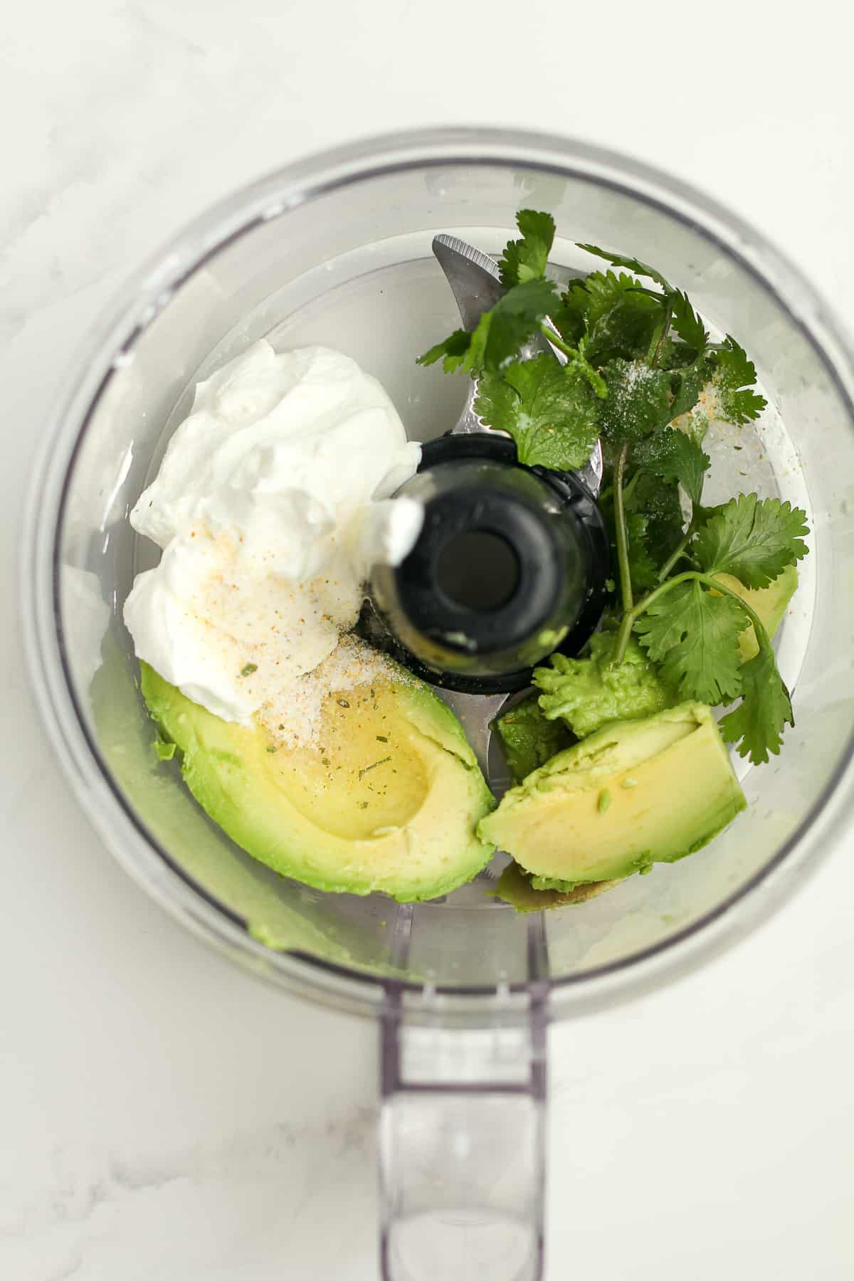 A food processor of the ingredients for the avocado Crema.