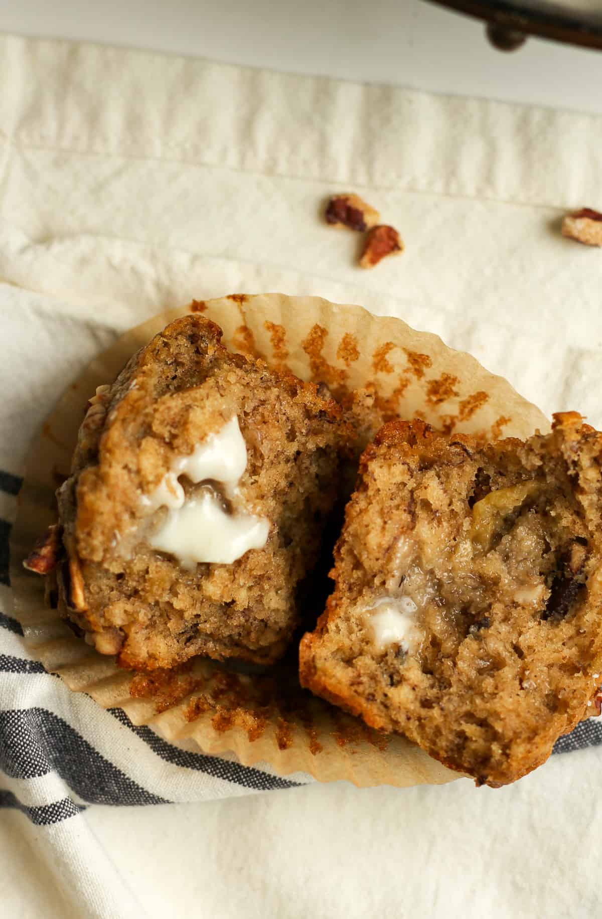 Closeup on a halved banana muffin with butter.