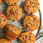 A platter of pecan banana muffins with pecans on top.