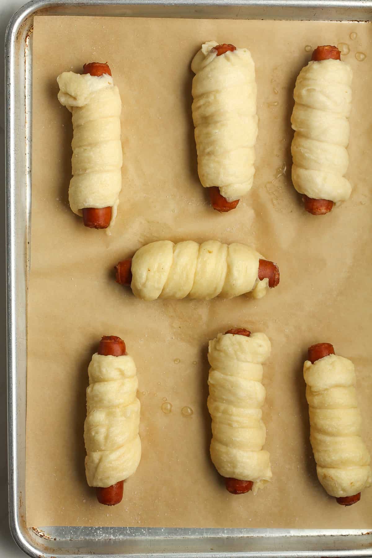 The pretzel dogs after boiling in baking soda, ready to bake.