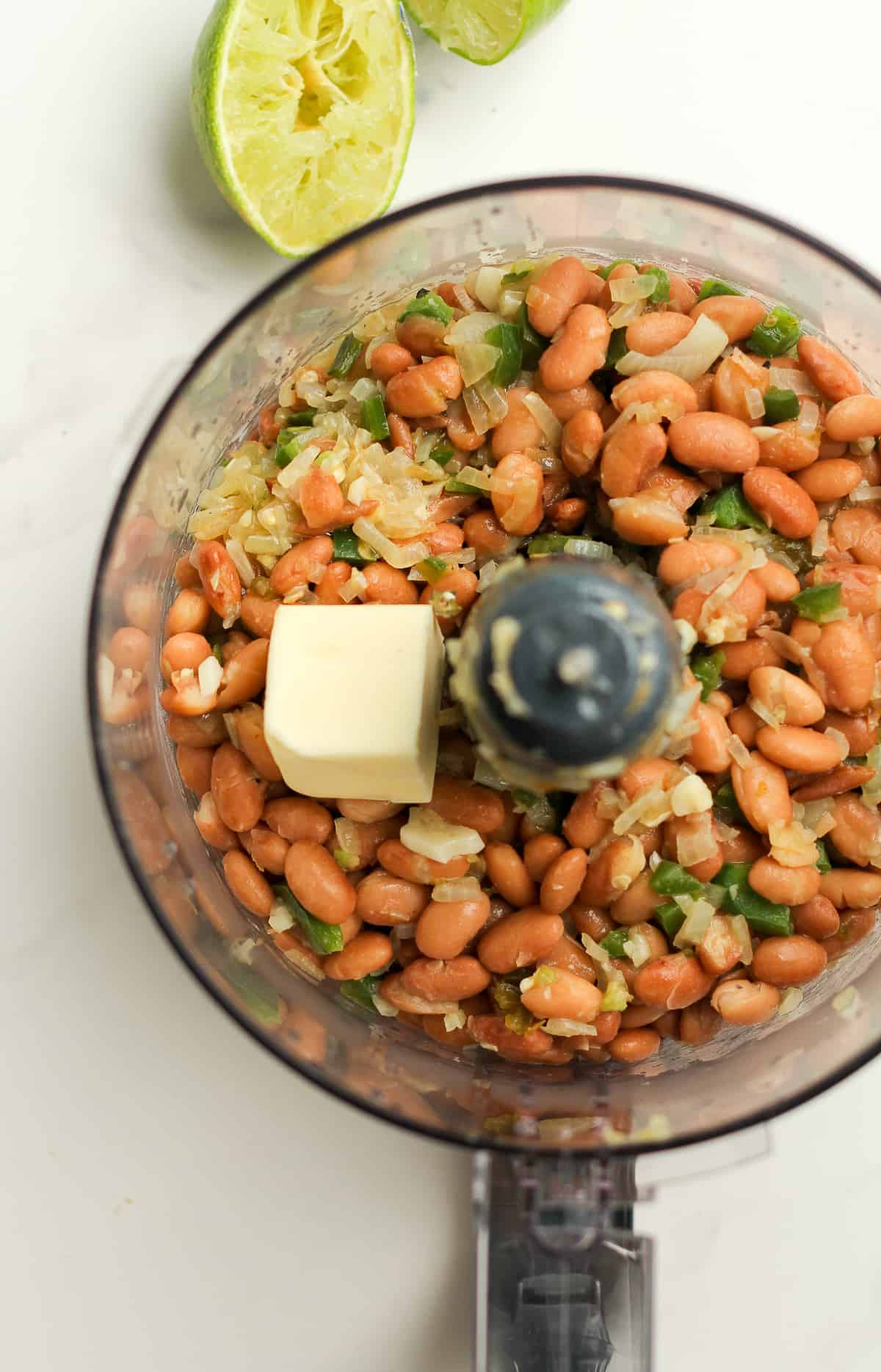 A food processor of pinto beans, sautéed veggies, and butter.