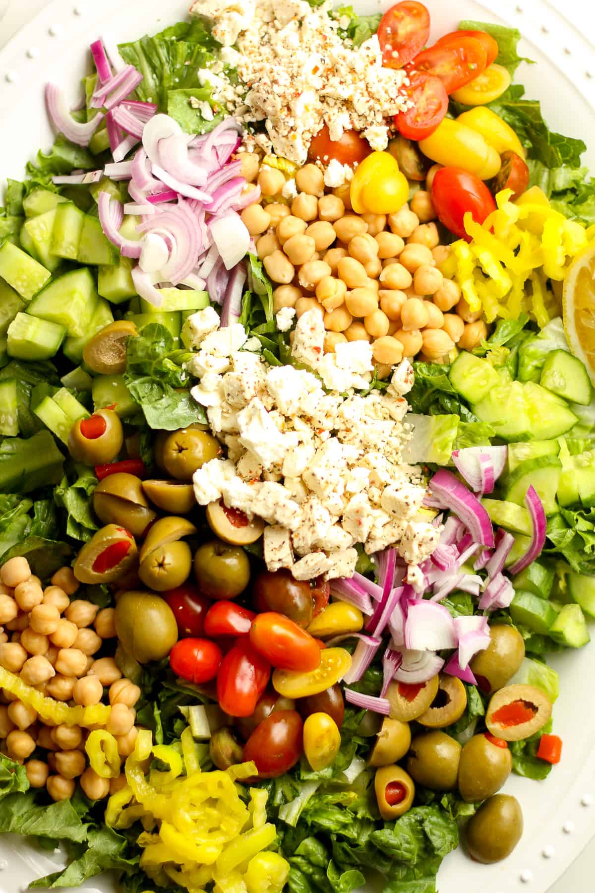 Closeup on a large platter of Greek chopped salad.