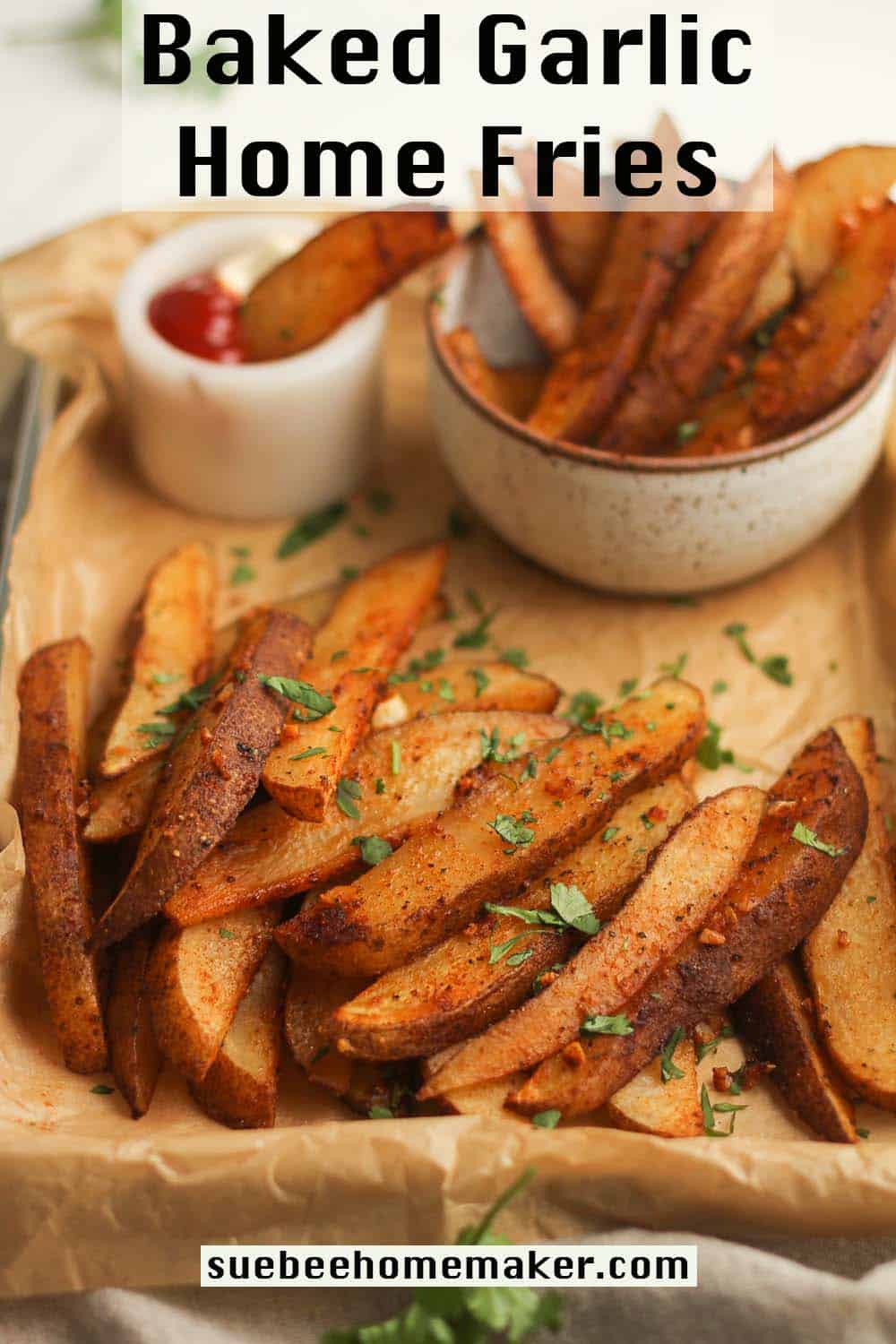 A pan of baked garlic home fries with a bowl of fries and a small bowl of ketchup and mayo.