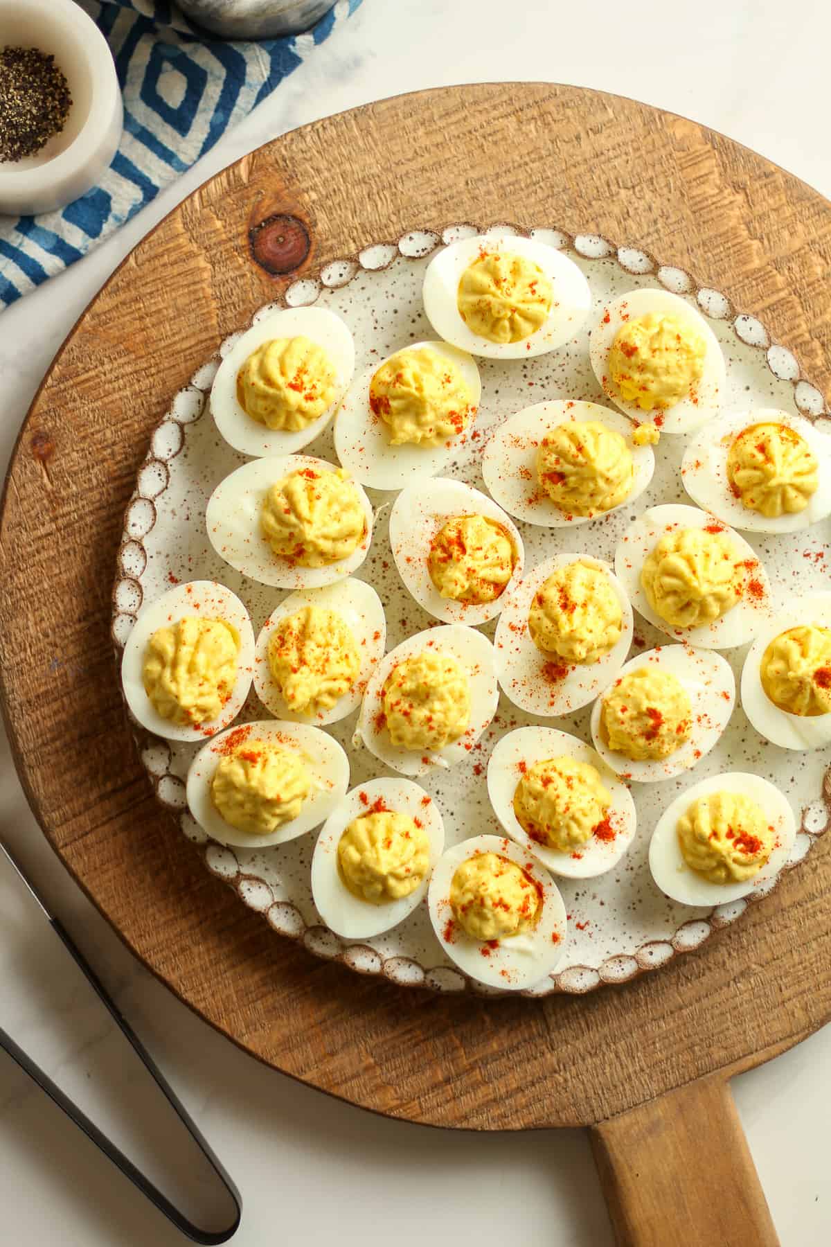 A plate on a wooden board with classic deviled eggs with apple cider vinegar.