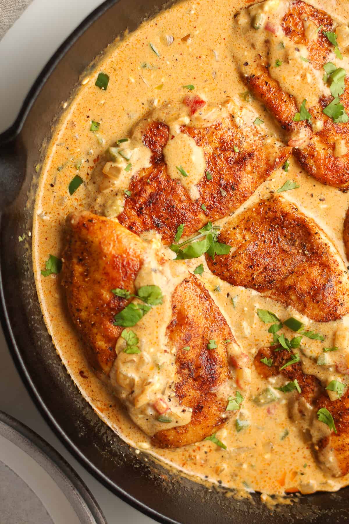 Closeup on the skillet of seared chicken in the jalapeño sauce.