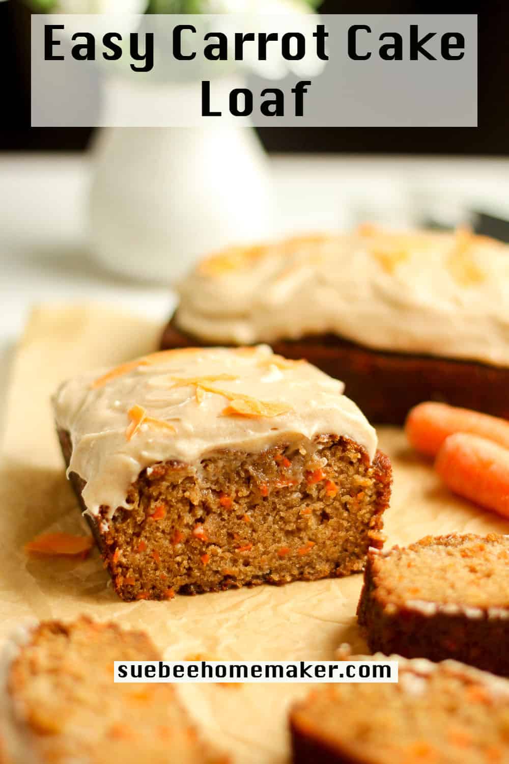 Side view of a chunk of carrot cake loaf, with slices beside it.