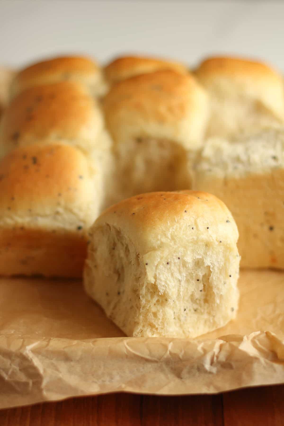 Side view of some dinner rolls, with a couple pulled apart.