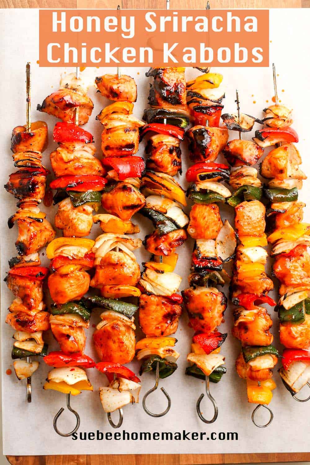 A cutting board of the kabobs after grilling, on the skewers.
