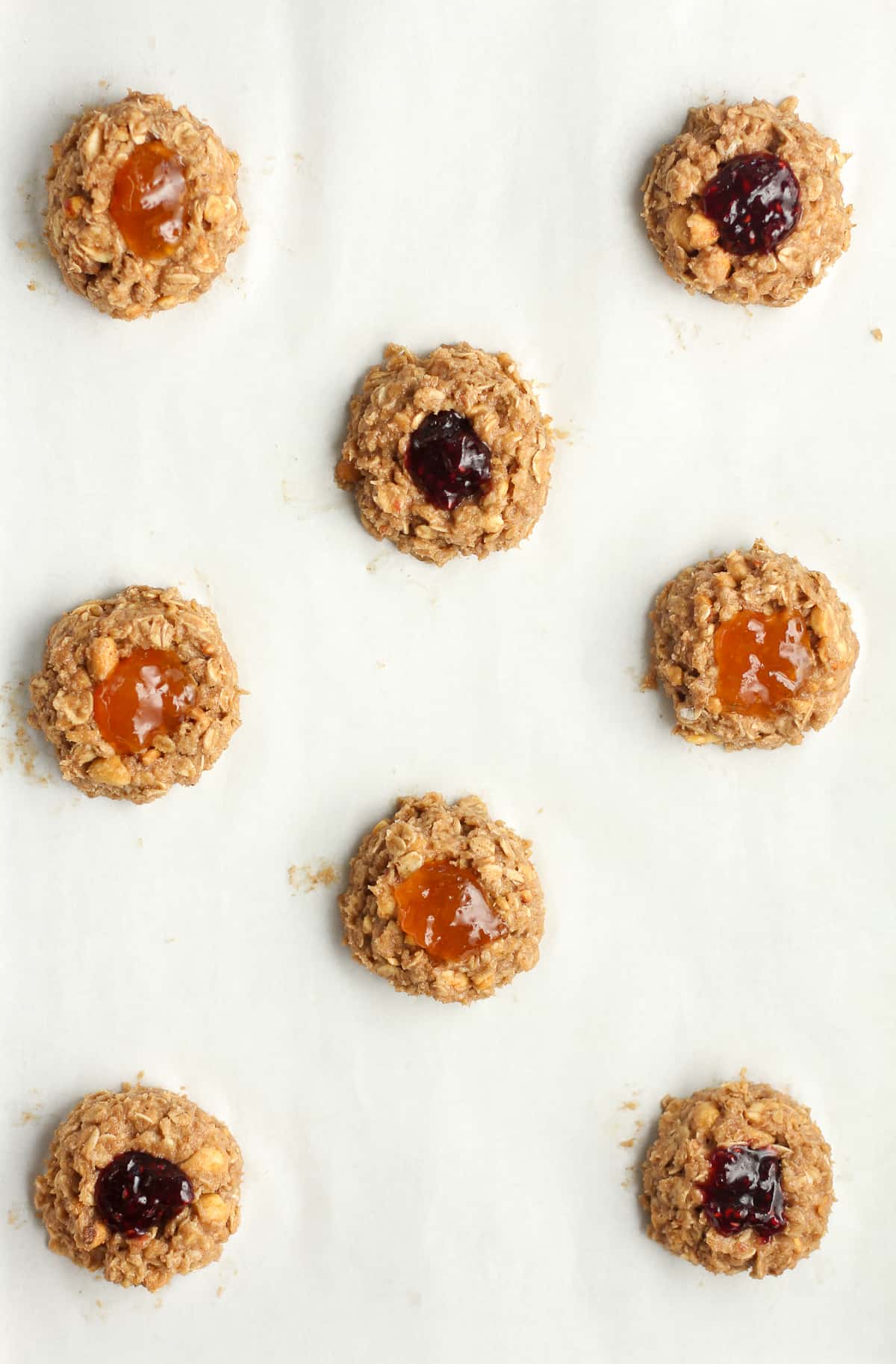 Parchment paper with the unbaked breakfast cookies.