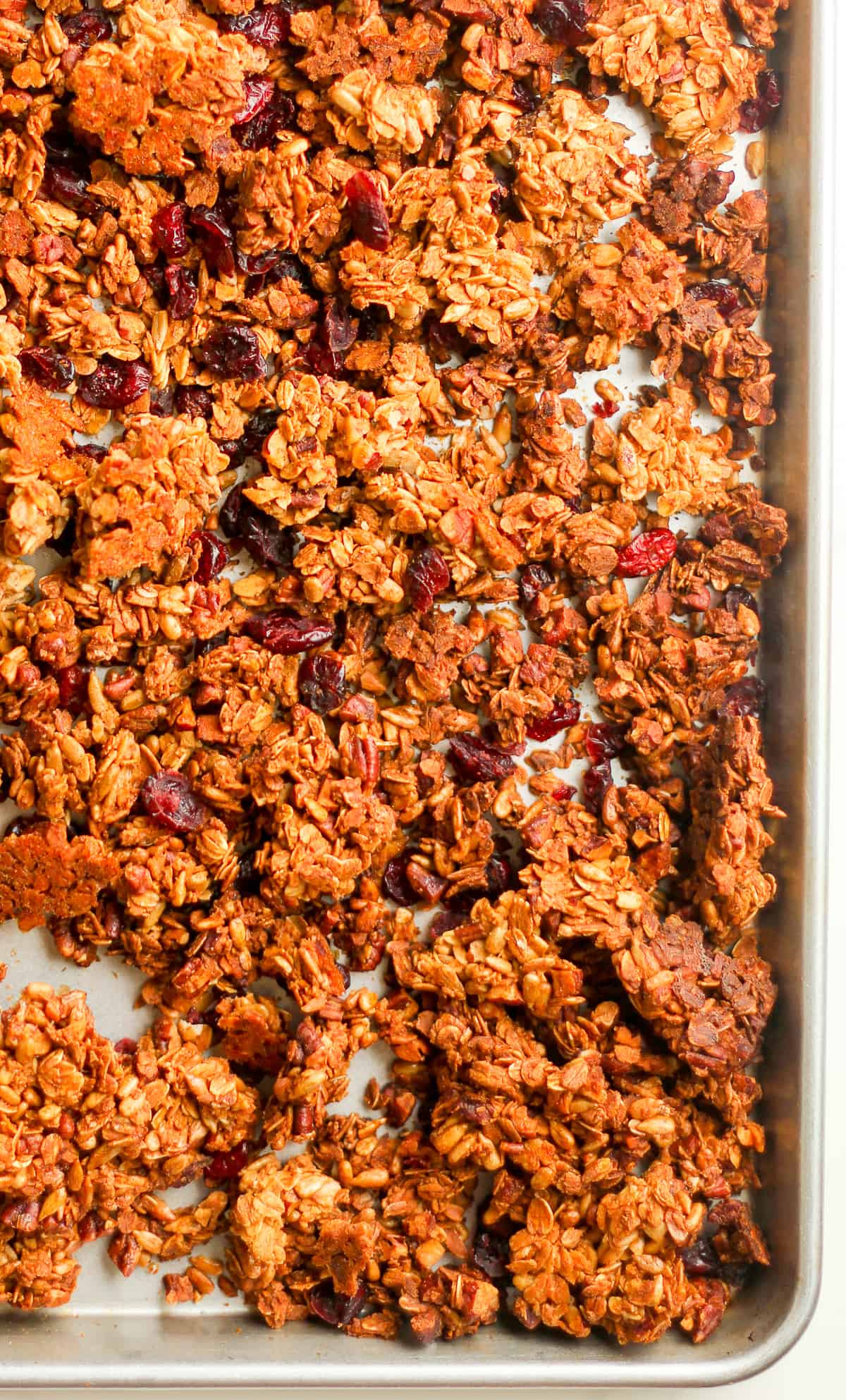 A corner of the sheet pan of just baked granola.