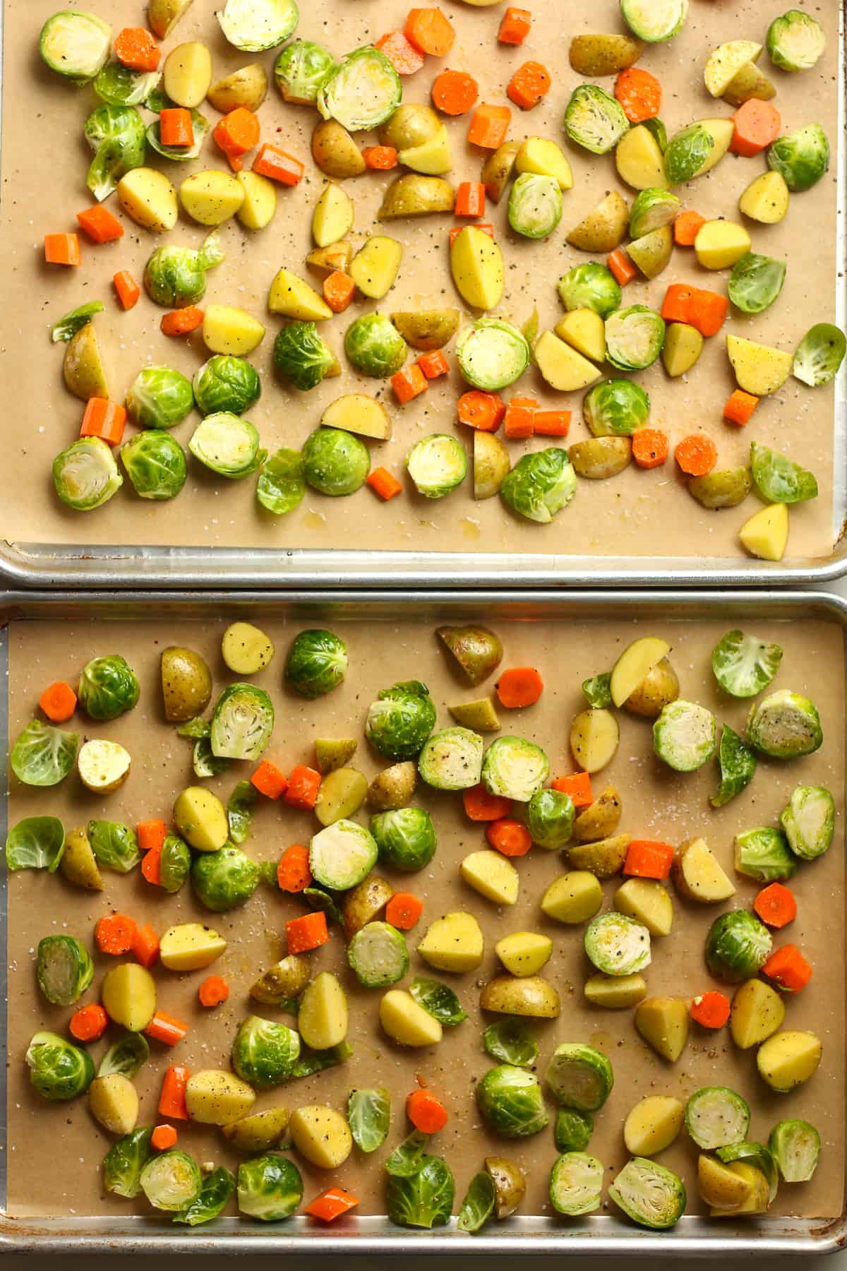Two sheet pans of chopped veggies ready to roast.