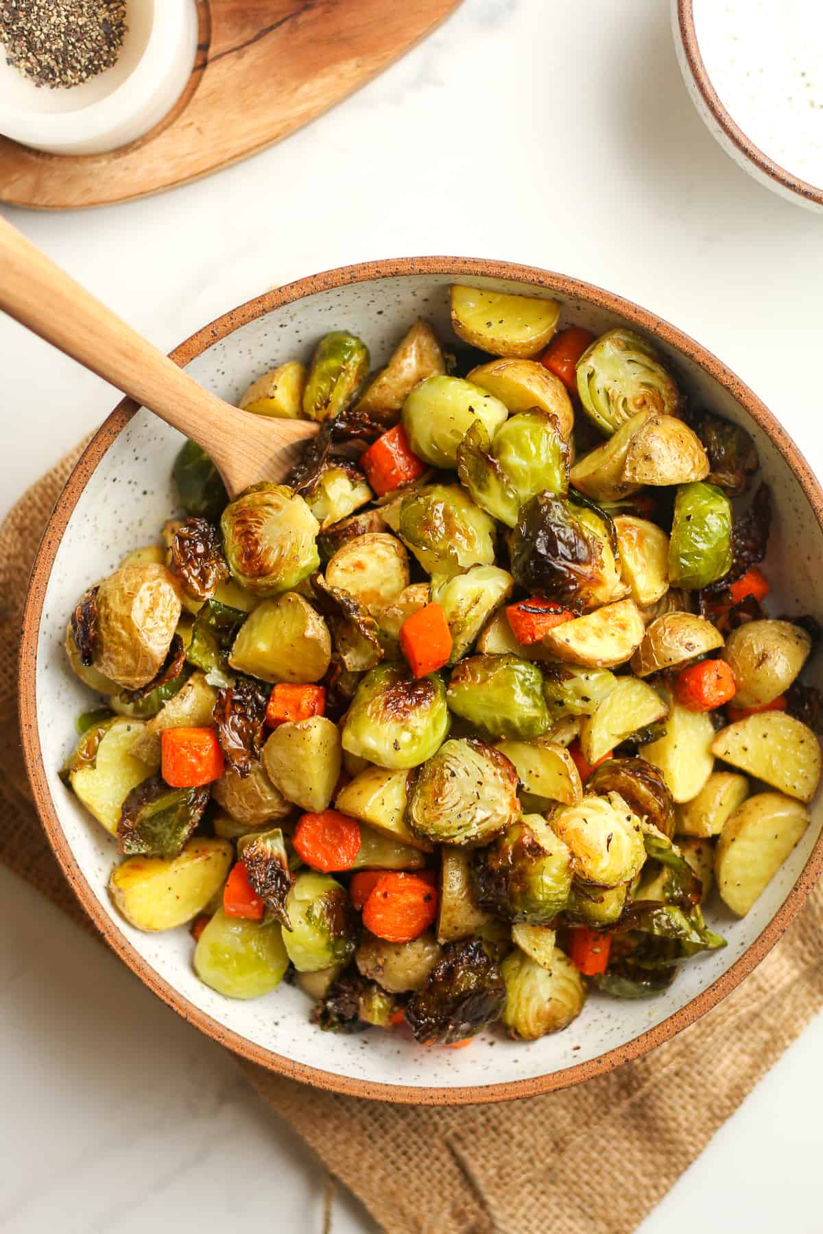 Overhead shot of a bowl of roasted potatoes, carrots, and Brussels sprouts.