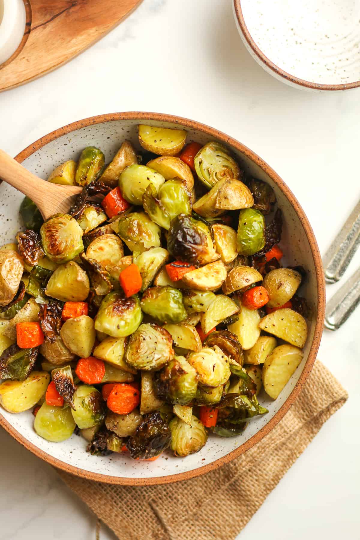 A partial view of a bowl of roasted veggies.