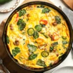 Closeup on a skillet of the sausage and spinach frittata.
