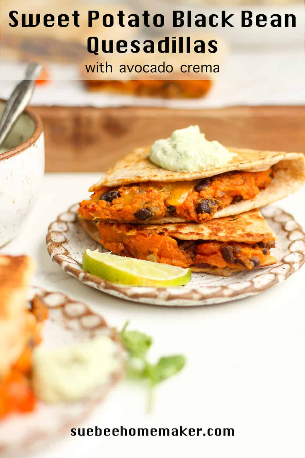 A plate of two stacked quesadillas with sweet potatoes and black beans.