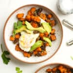 Two bowls of sweet potato breakfast skillet with eggs.